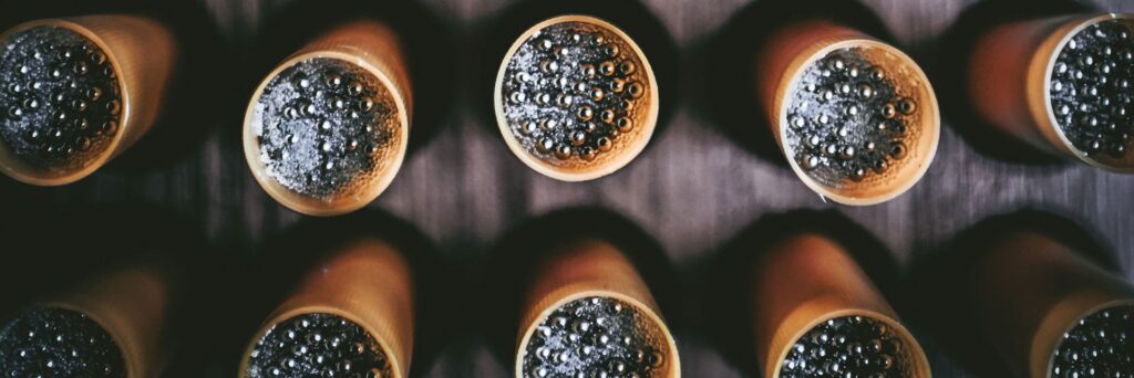 Close-up of tungsten super shot pellets loaded in handcrafted Apex Ammunition shotgun shells, premium quality for precision hunting.